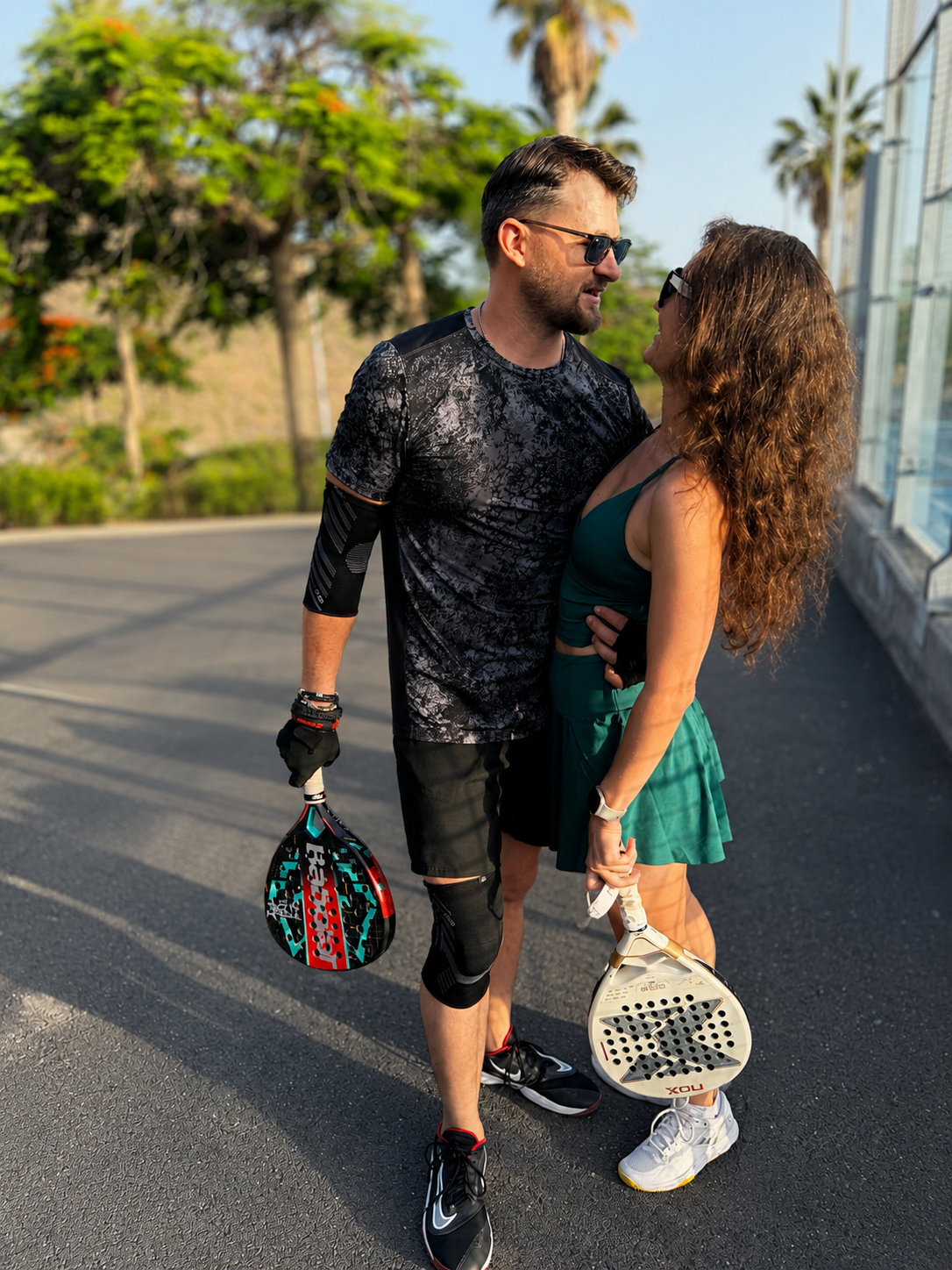 Two padel players with rackets after a sunset session in Tenerife